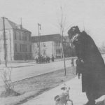 A woman with her dog on the street