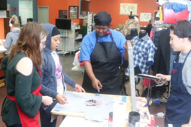 Teens use screen printing equipment to make a T-shirt